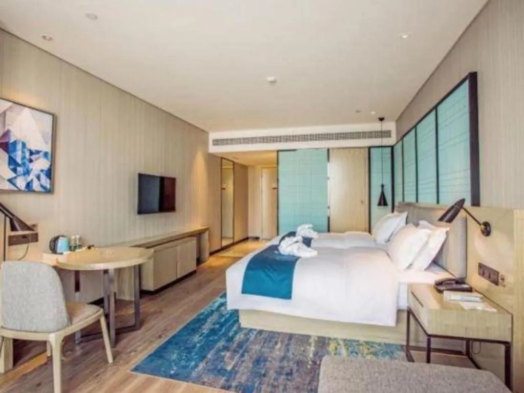 Bed in Echarm Hotel Qionghai Wanquan River