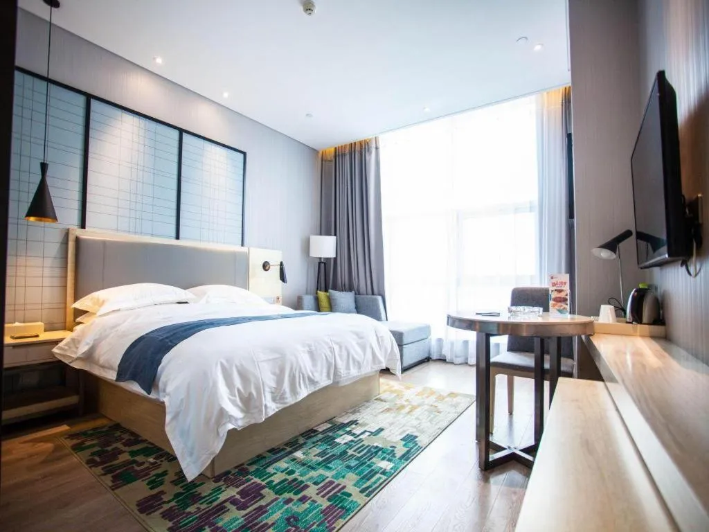 Bed in Echarm Hotel Qionghai Wanquan River