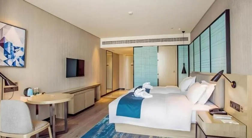 Bed in Echarm Hotel Qionghai Wanquan River