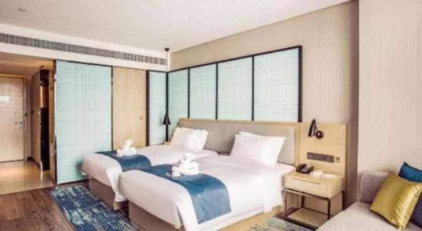 Bed in Echarm Hotel Qionghai Wanquan River