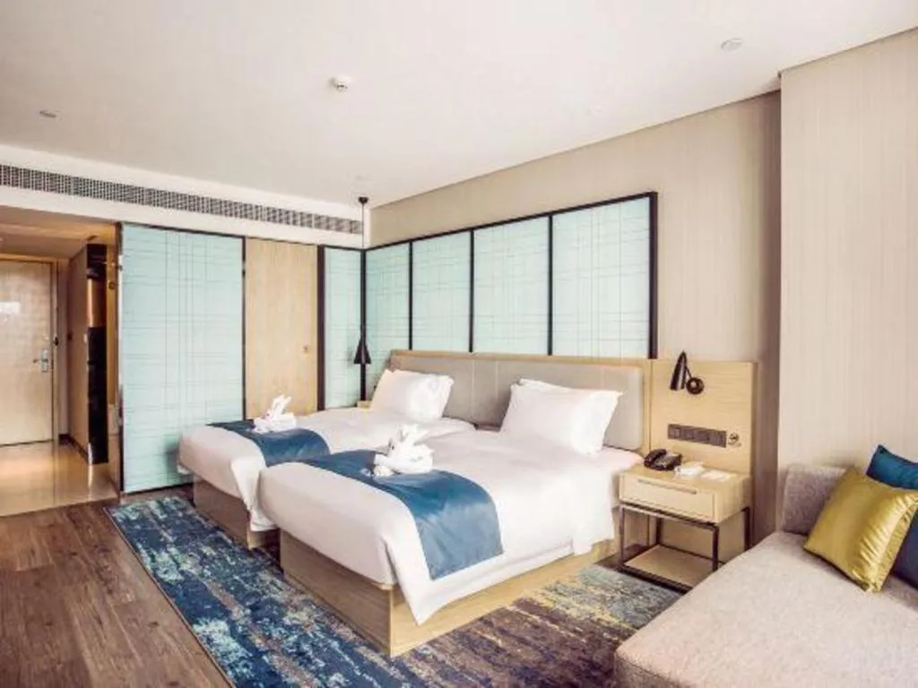 Bed in Echarm Hotel Qionghai Wanquan River