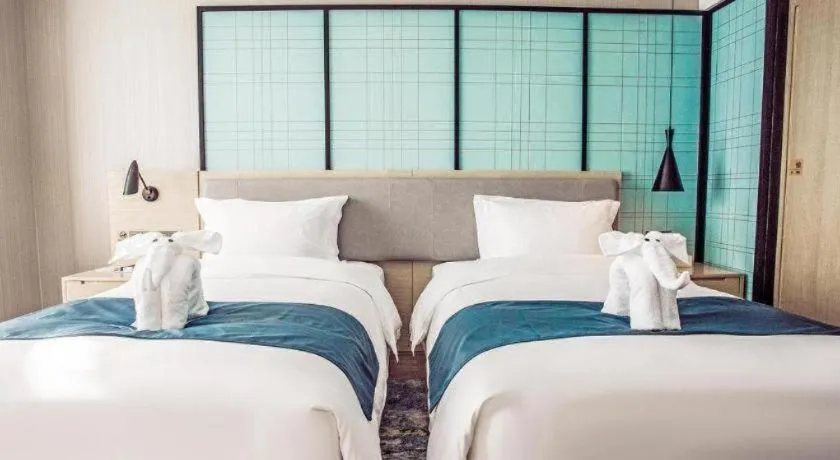 Bed in Echarm Hotel Qionghai Wanquan River