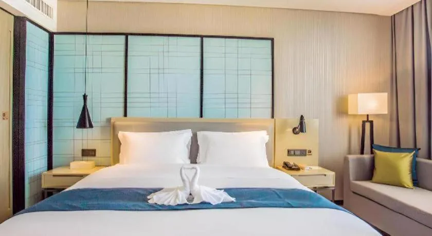 Bed in Echarm Hotel Qionghai Wanquan River