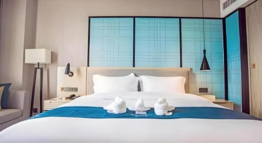 Bed in Echarm Hotel Qionghai Wanquan River