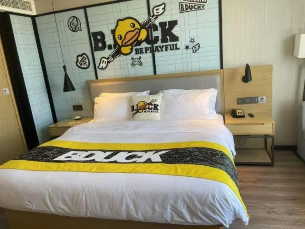 Bed in Echarm Hotel Qionghai Wanquan River