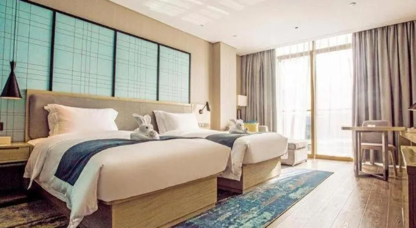 Bed in Echarm Hotel Qionghai Wanquan River