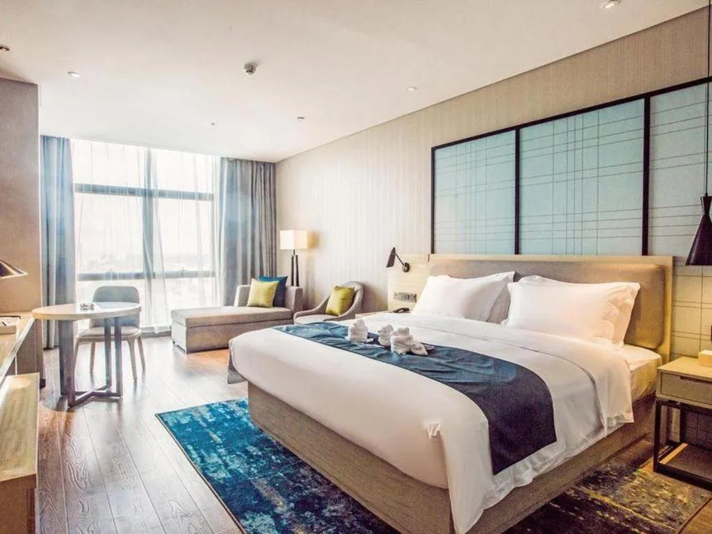 Bed in Echarm Hotel Qionghai Wanquan River