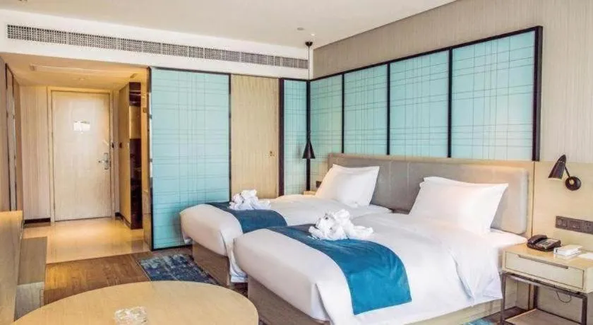 Bed in Echarm Hotel Qionghai Wanquan River