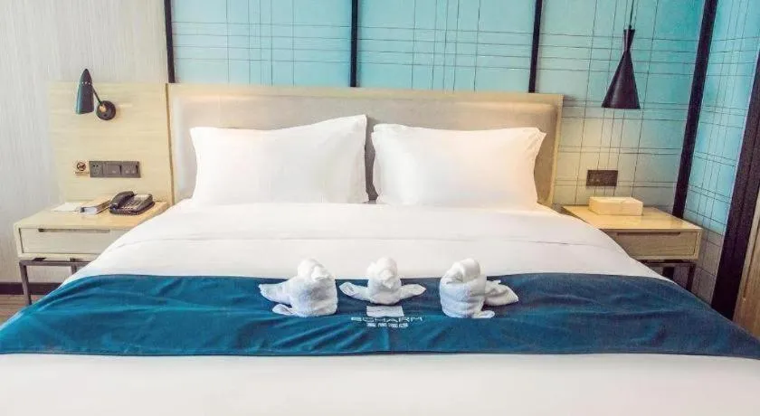 Bed in Echarm Hotel Qionghai Wanquan River