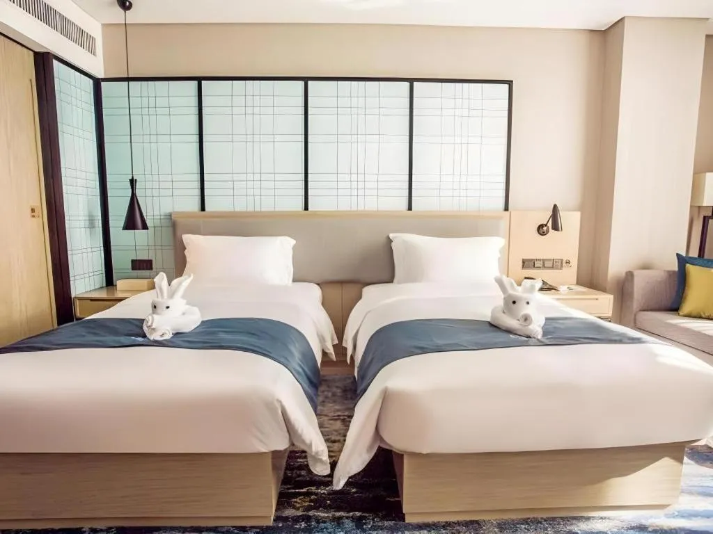 Bed in Echarm Hotel Qionghai Wanquan River