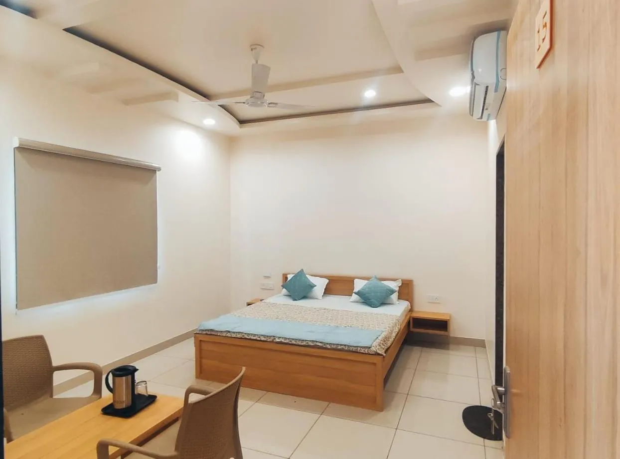 Seating area, Bed in Hotel Rajvi Residency A Unit Of Jas Hotels And Resorts