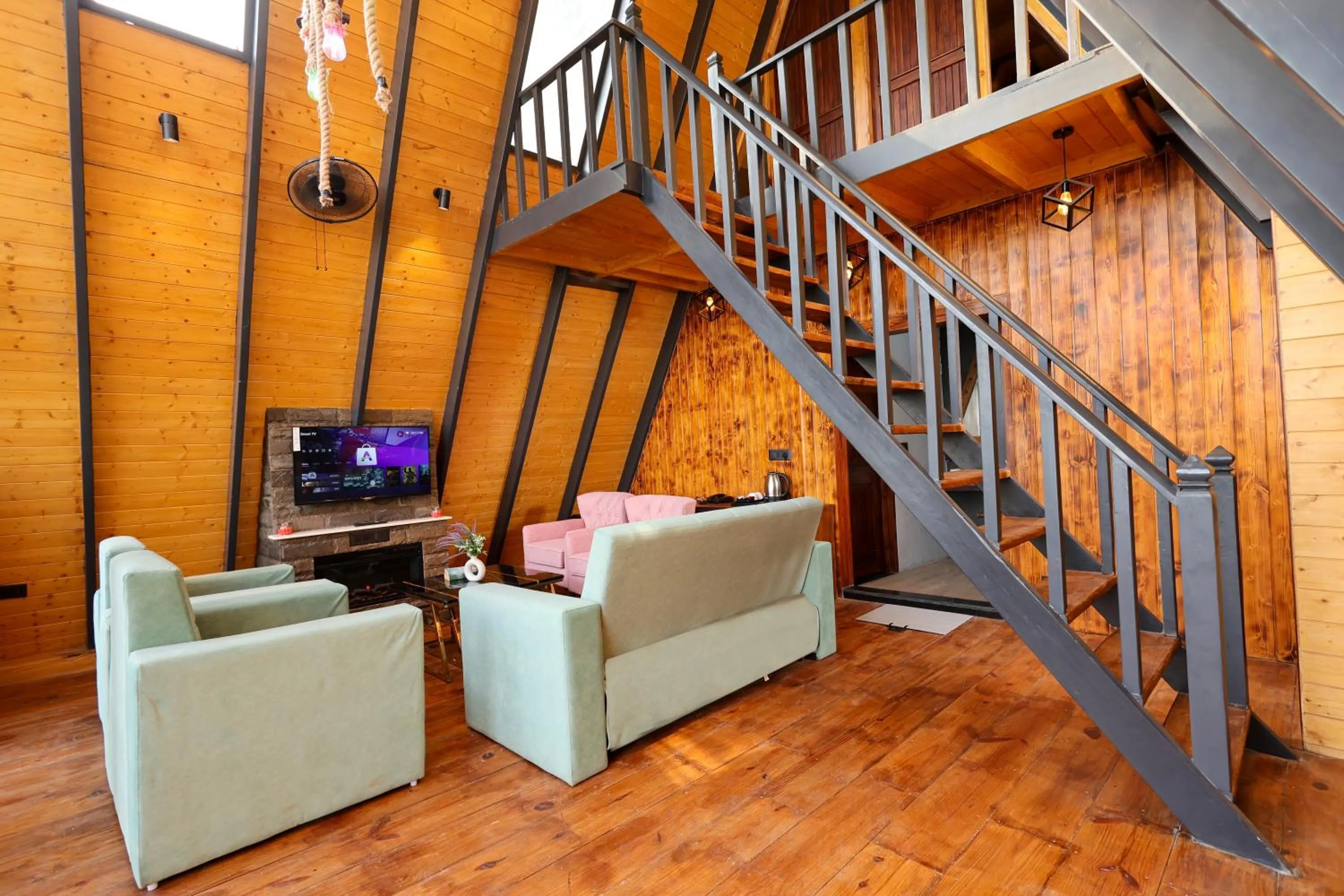 Communal lounge/ TV room in Koro Treehouse Resort Luxury Wooden Cottages and Villas with Private Pool