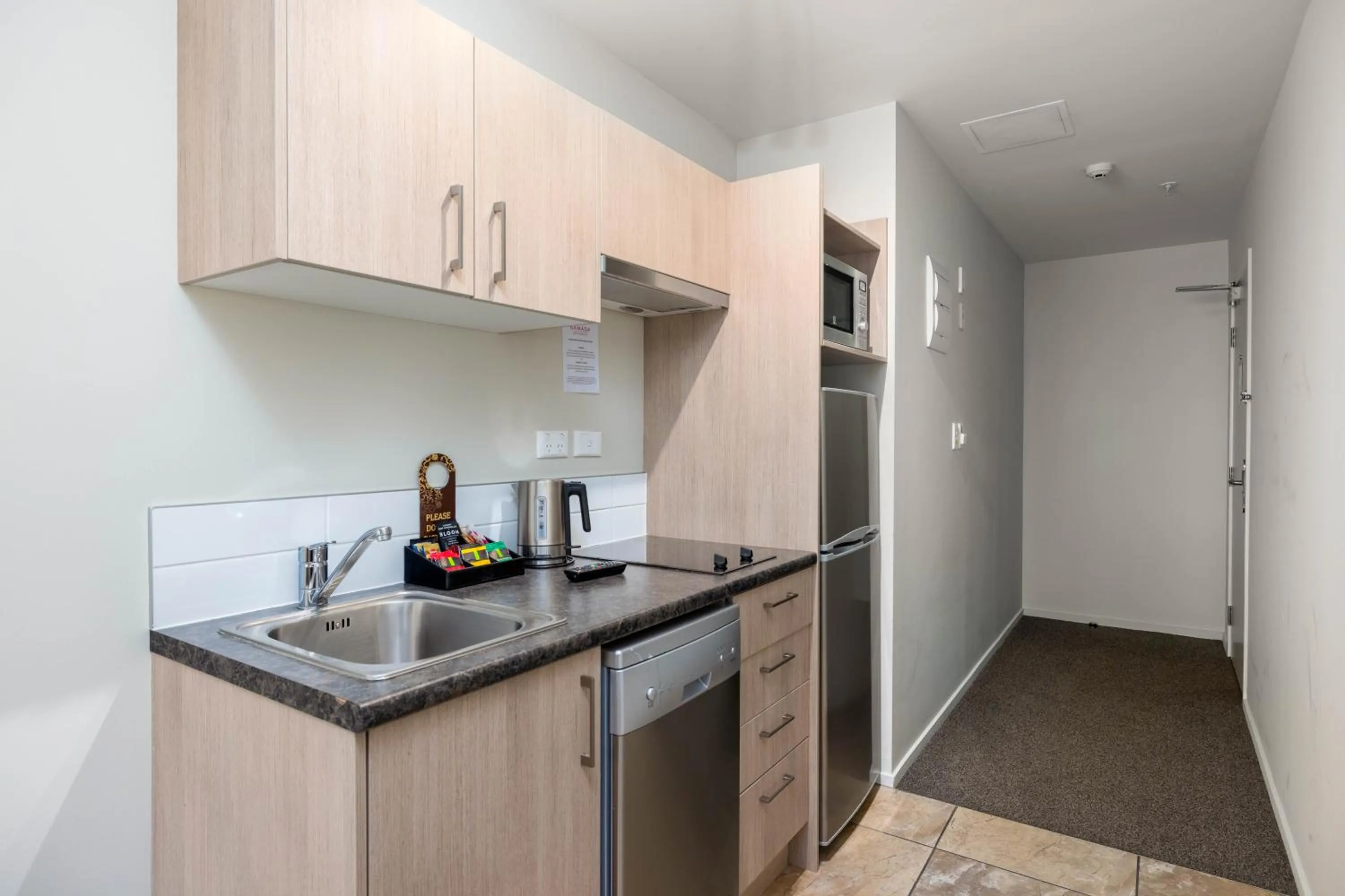 Kitchen or kitchenette in Ramada Suites by Wyndham Christchurch City
