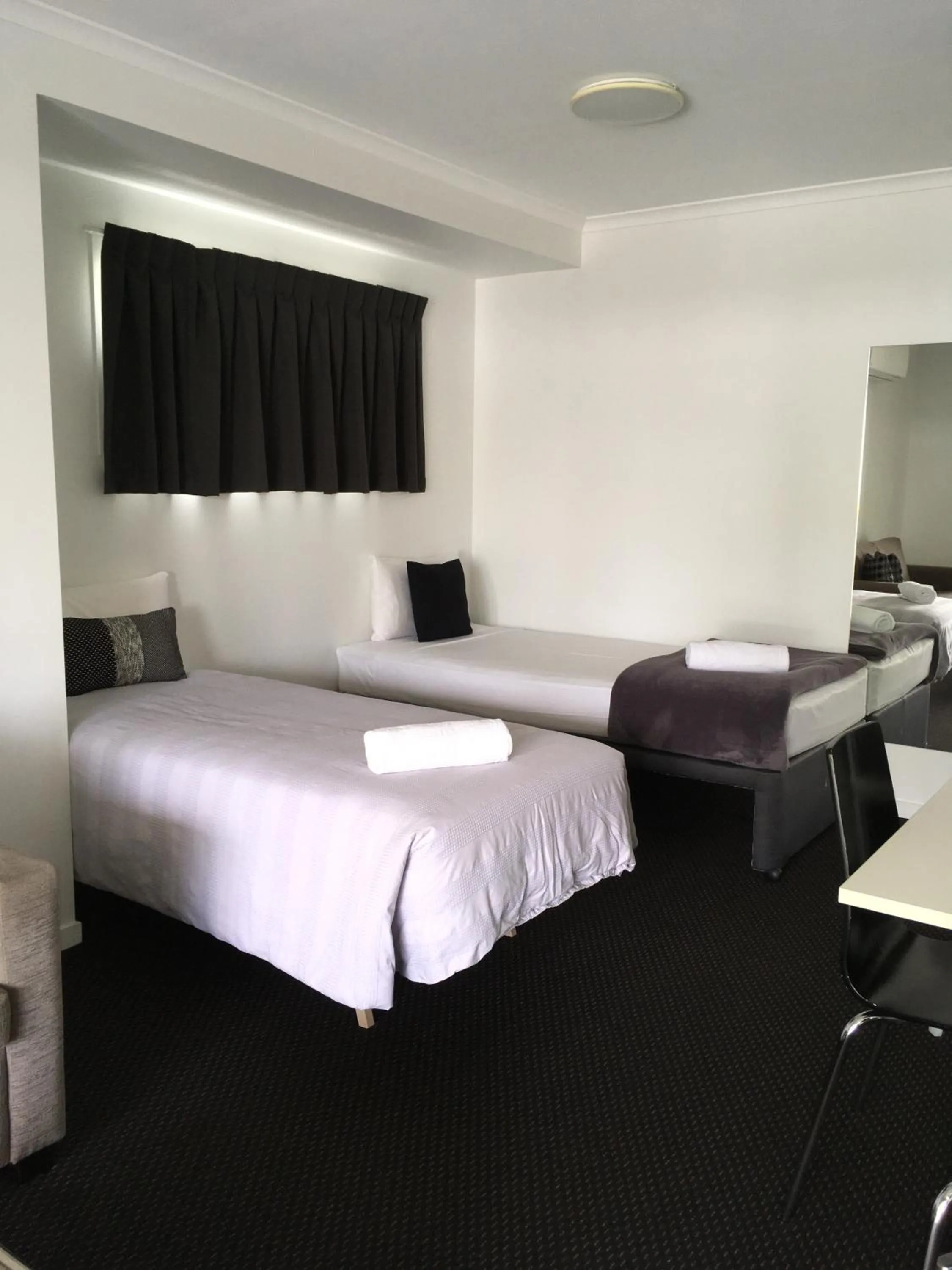 Bed in Cooroy Luxury Motel Apartments