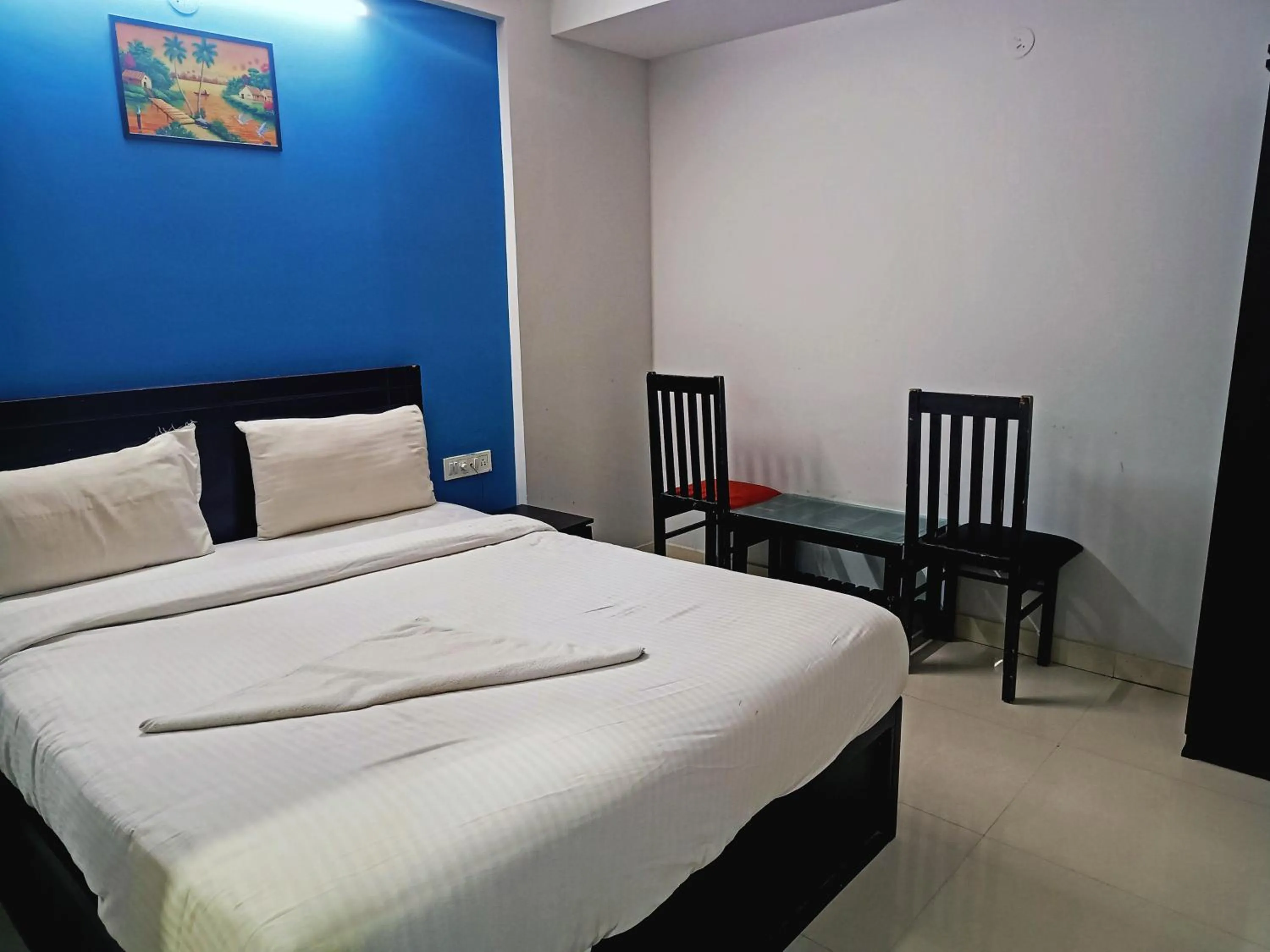 Bedroom in Delta Inn Madiwala