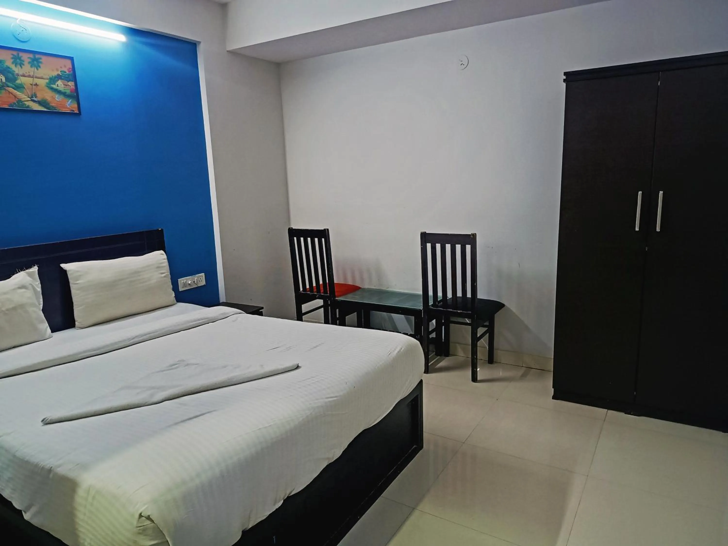 Bedroom in Delta Inn Madiwala