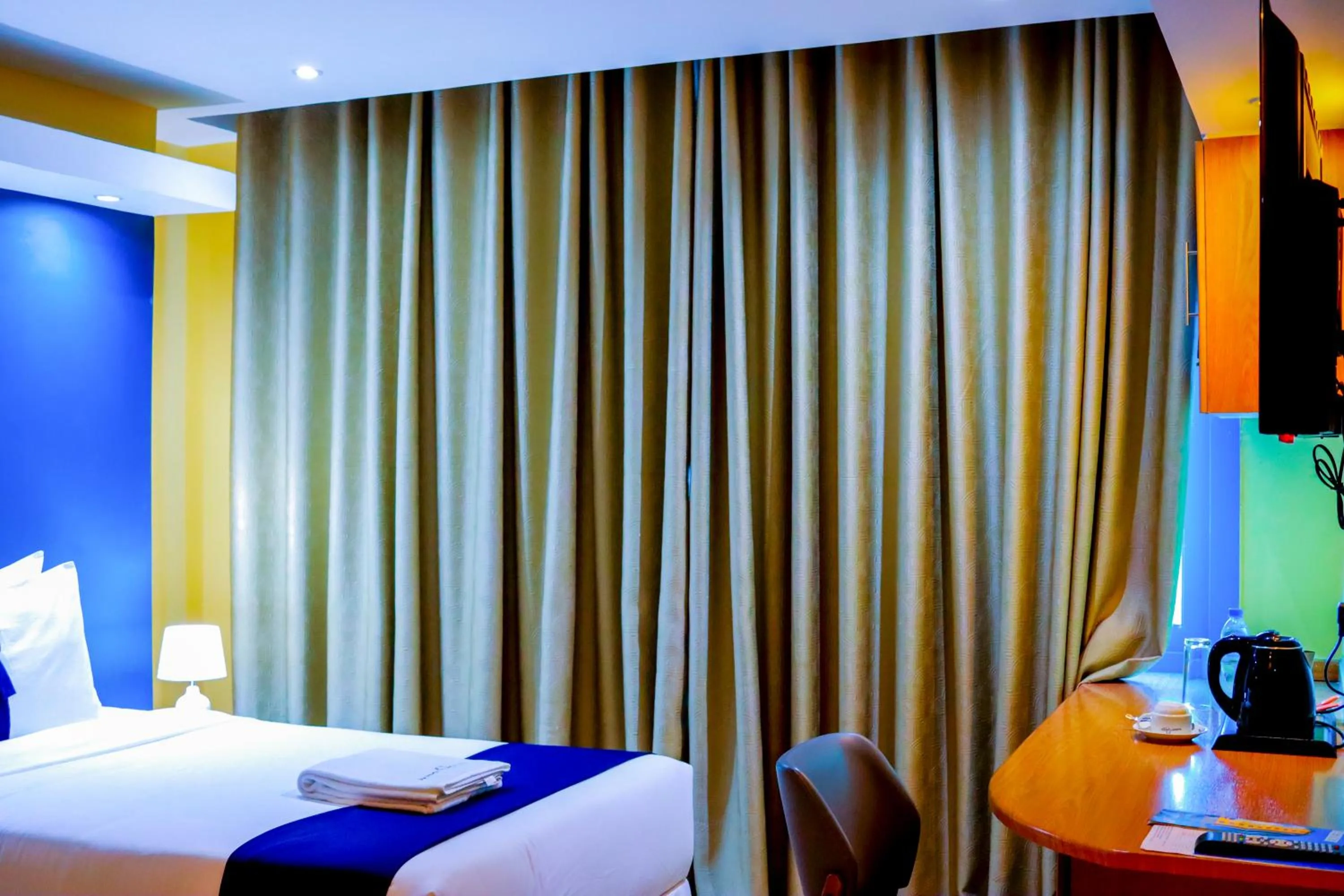 Bed in Parrot Hotel Arusha