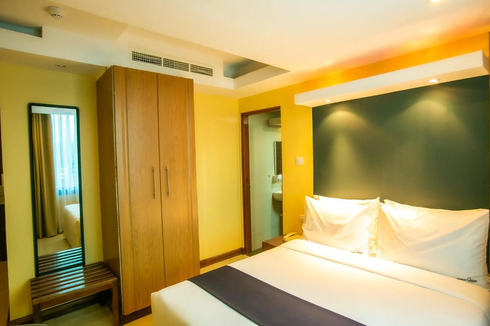 Bed in Parrot Hotel Arusha