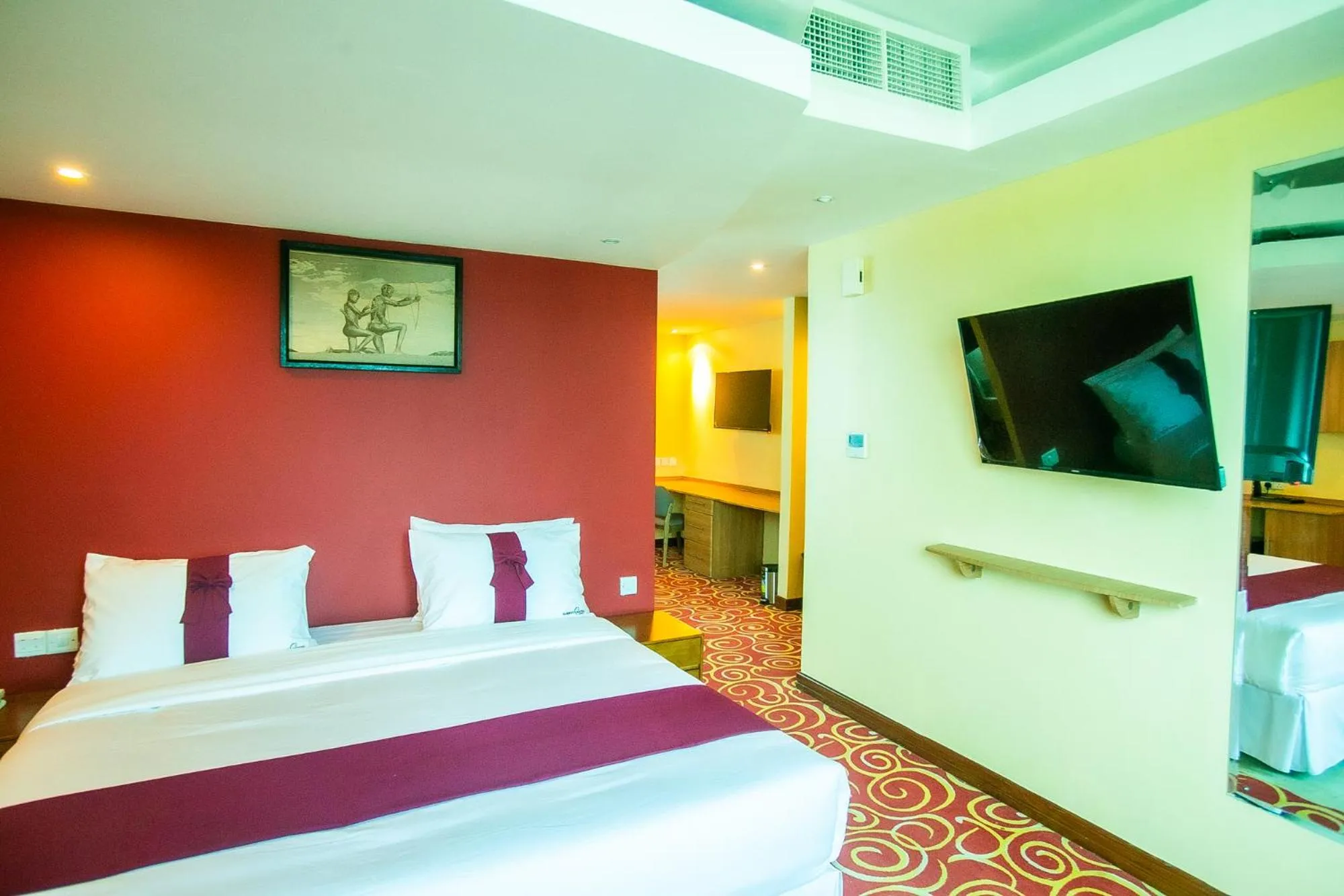 Communal lounge/ TV room, Bed in Parrot Hotel Arusha