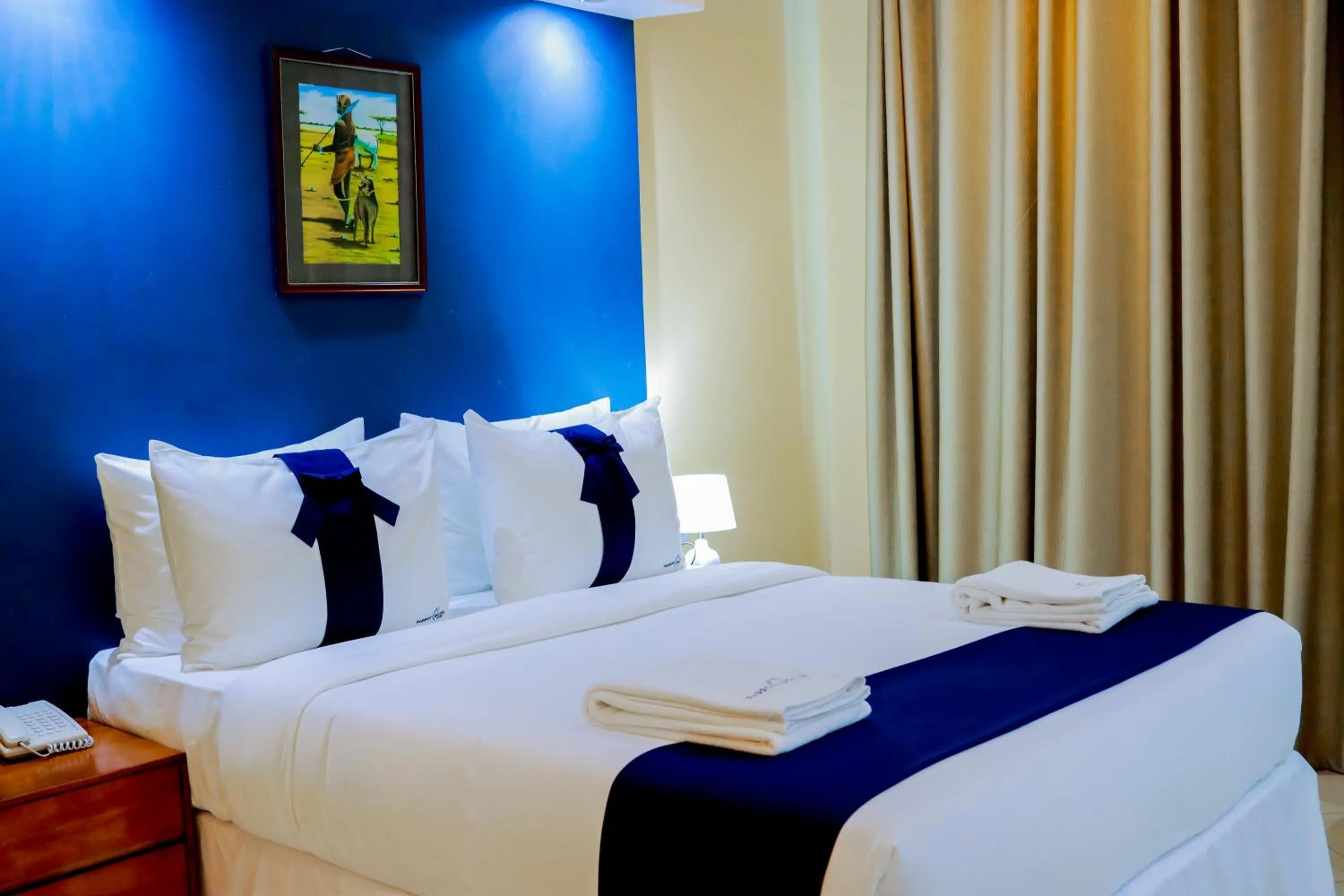 Bed in Parrot Hotel Arusha