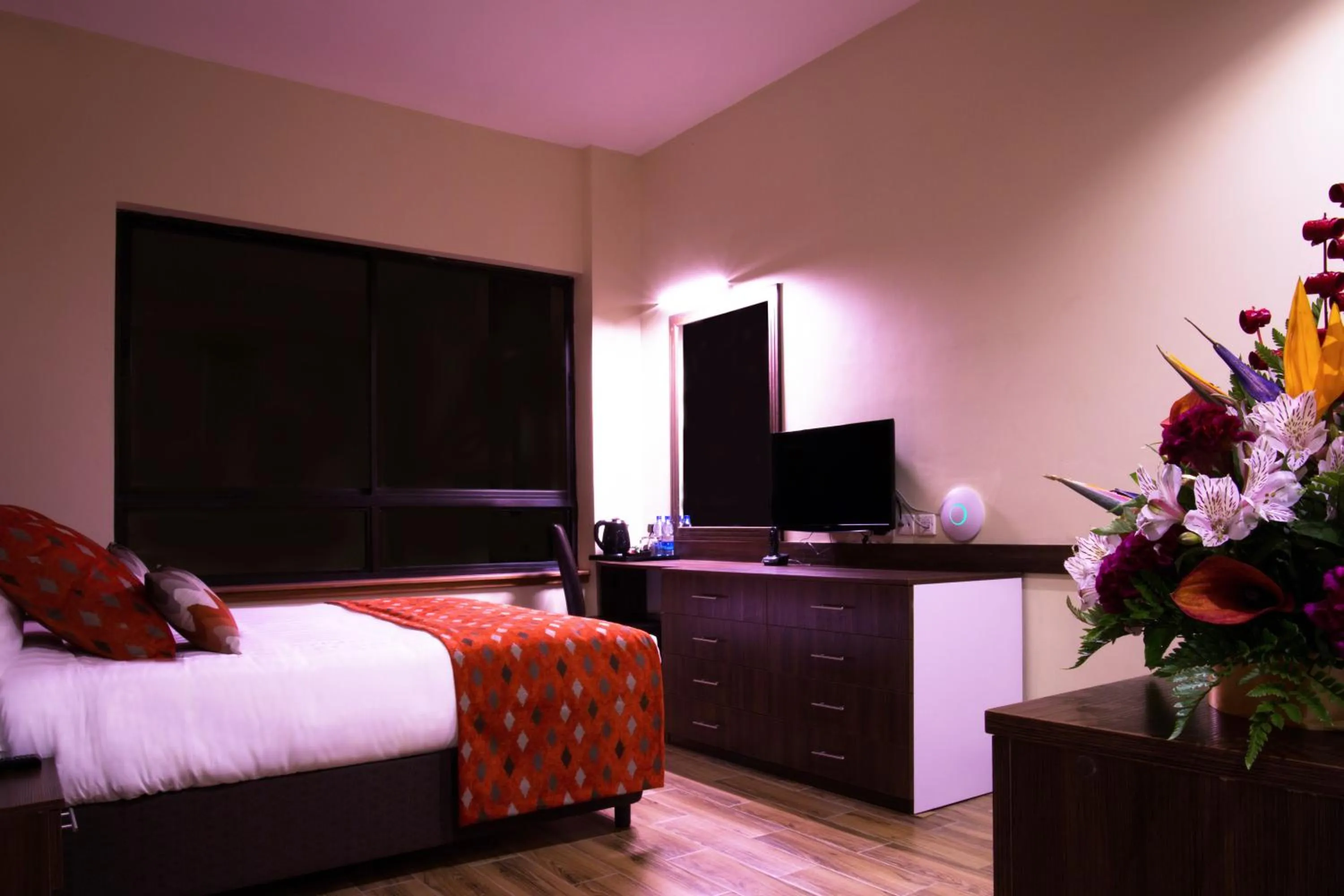 Bed in Bidwood Suite Hotel