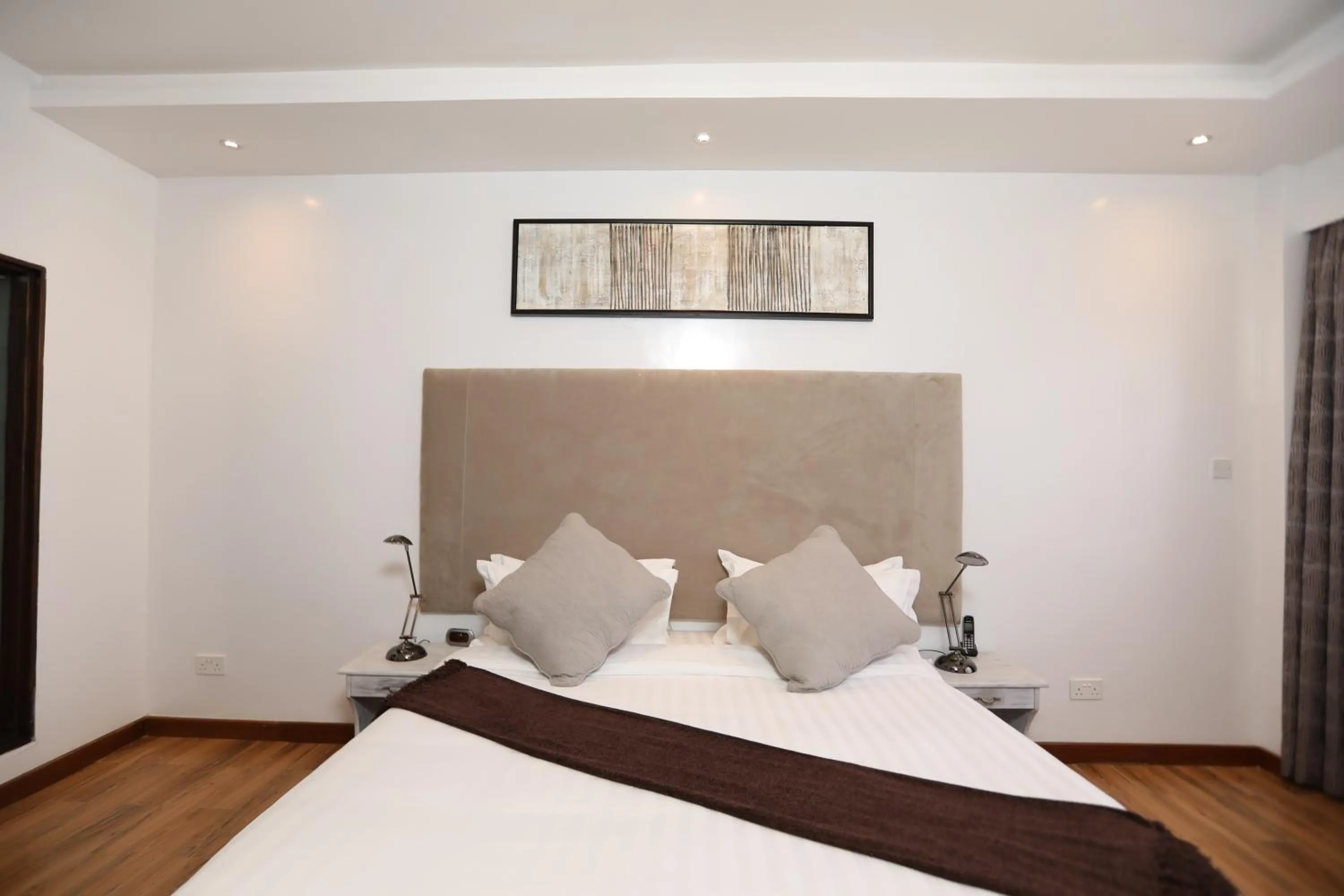 Bed in Bidwood Suite Hotel