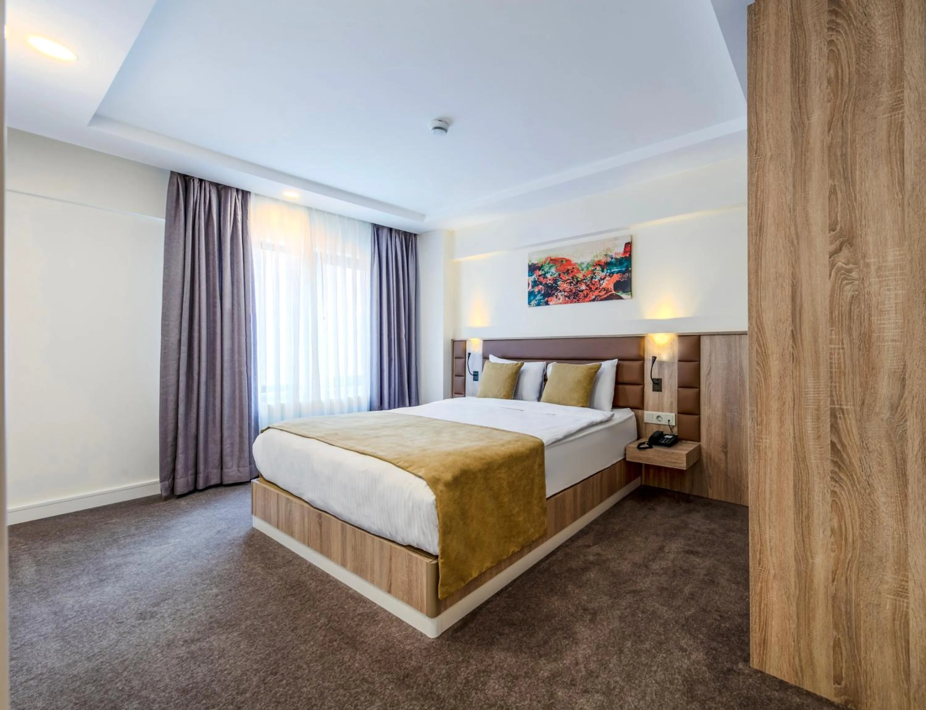 Bed in Roys Hotel & Suites