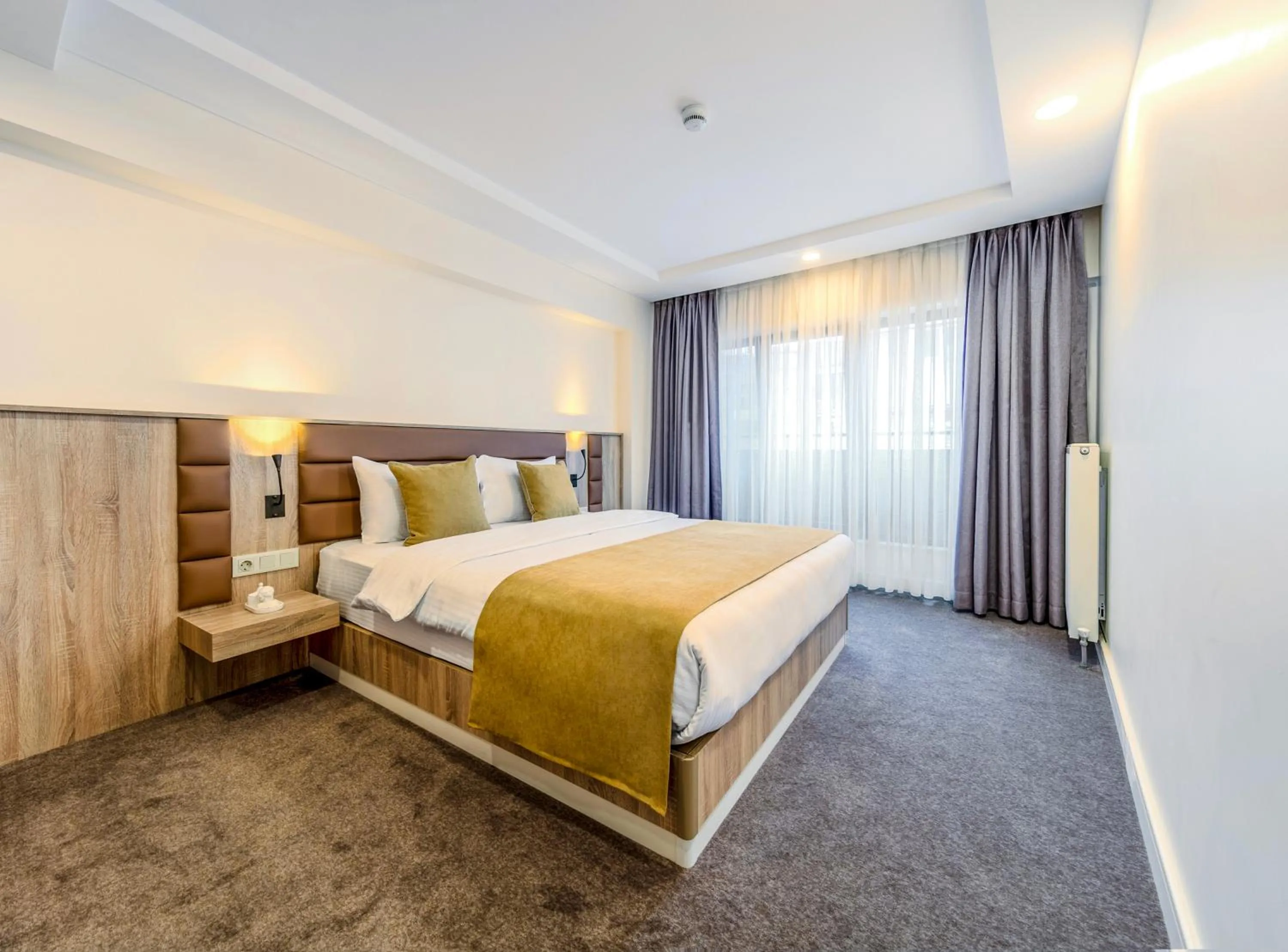 Bed in Roys Hotel & Suites