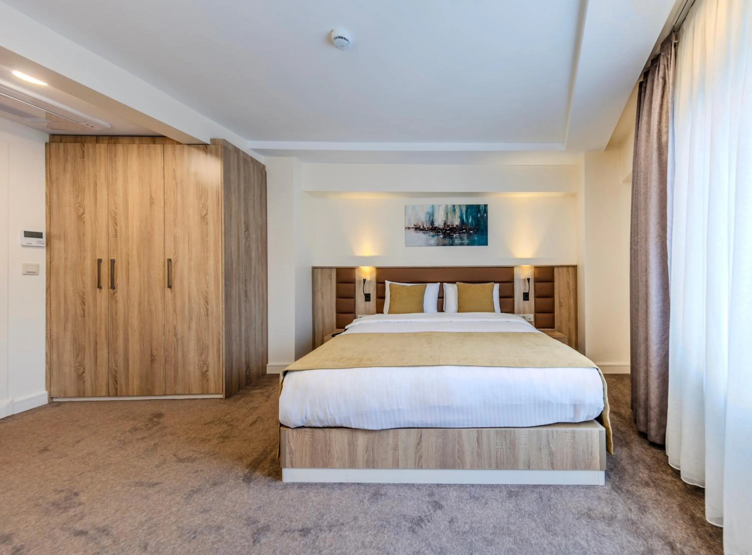 Bed in Roys Hotel & Suites