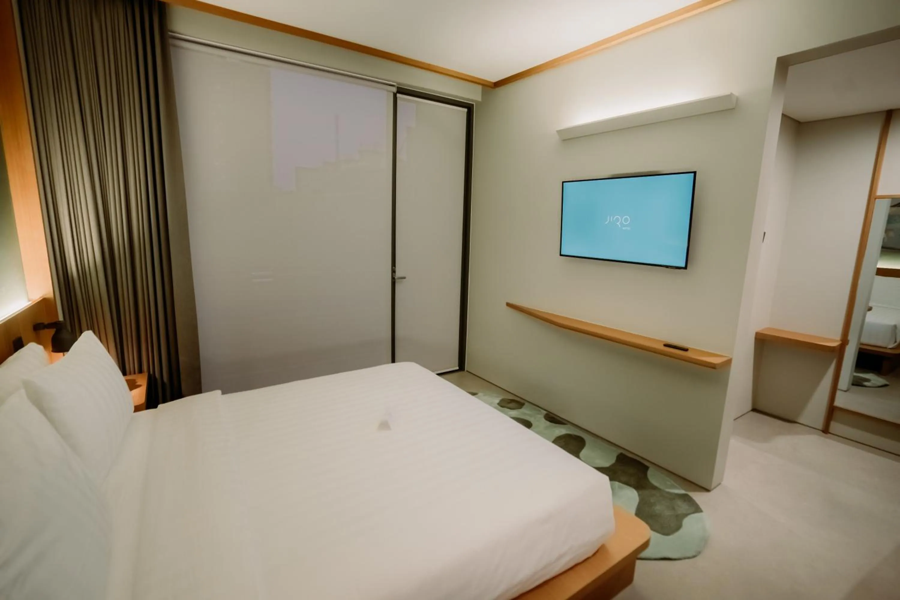 Bed in Jiro Hotel