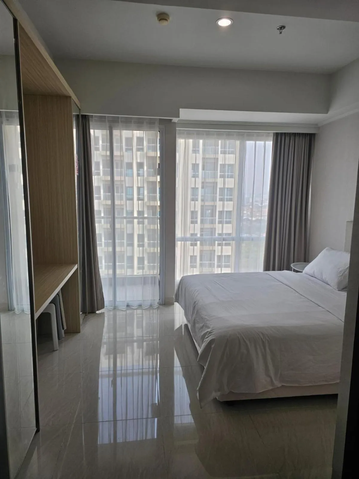 Bed in Green Sedayu Apartment Suite by Ellison