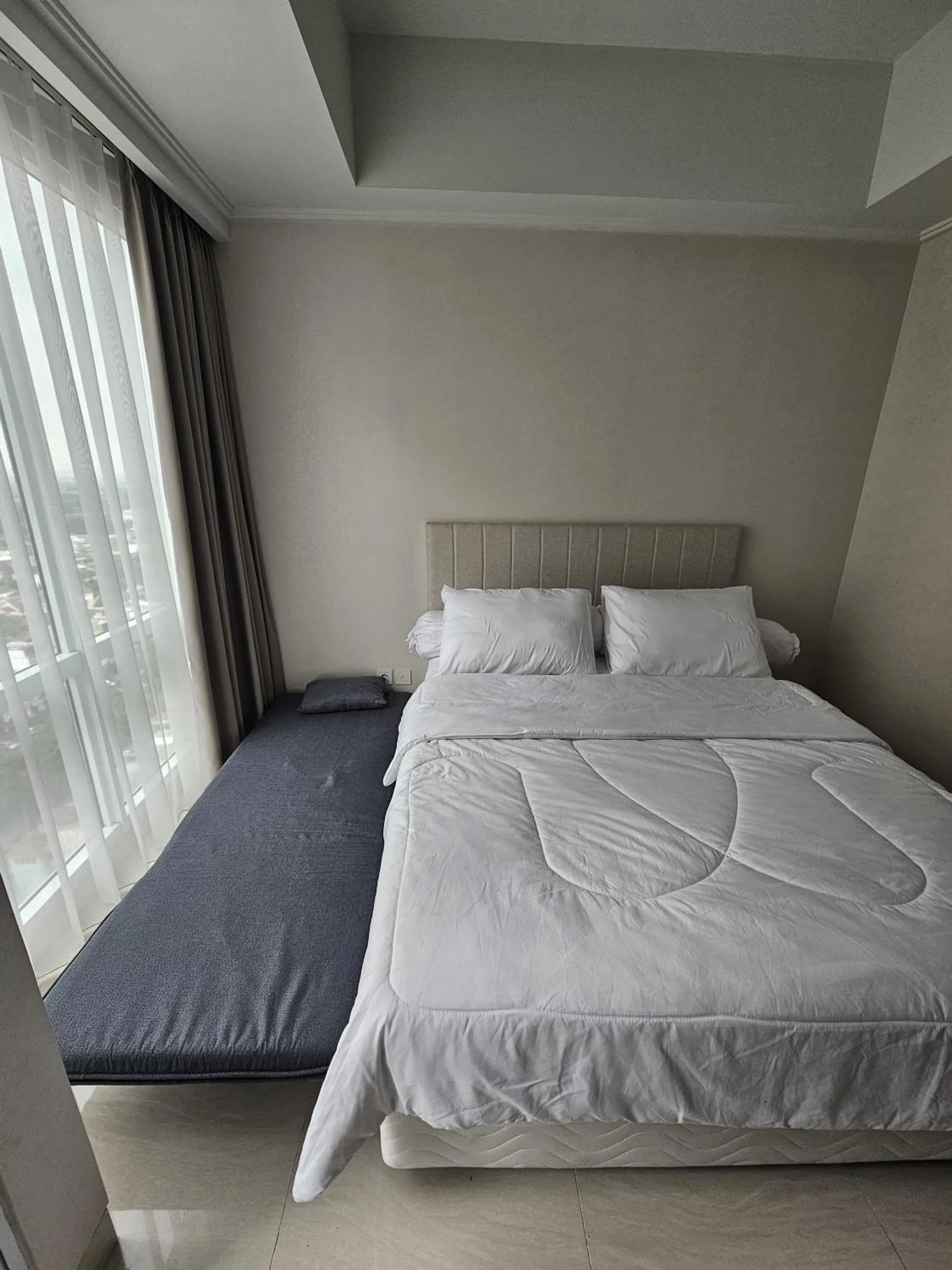 Bed in Green Sedayu Apartment Suite by Ellison