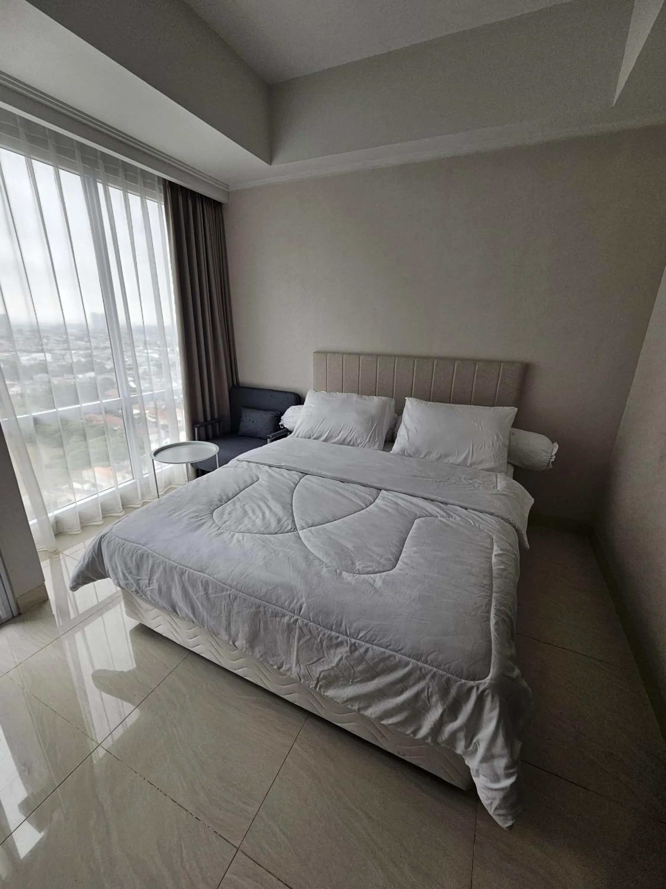 Bed in Green Sedayu Apartment Suite by Ellison