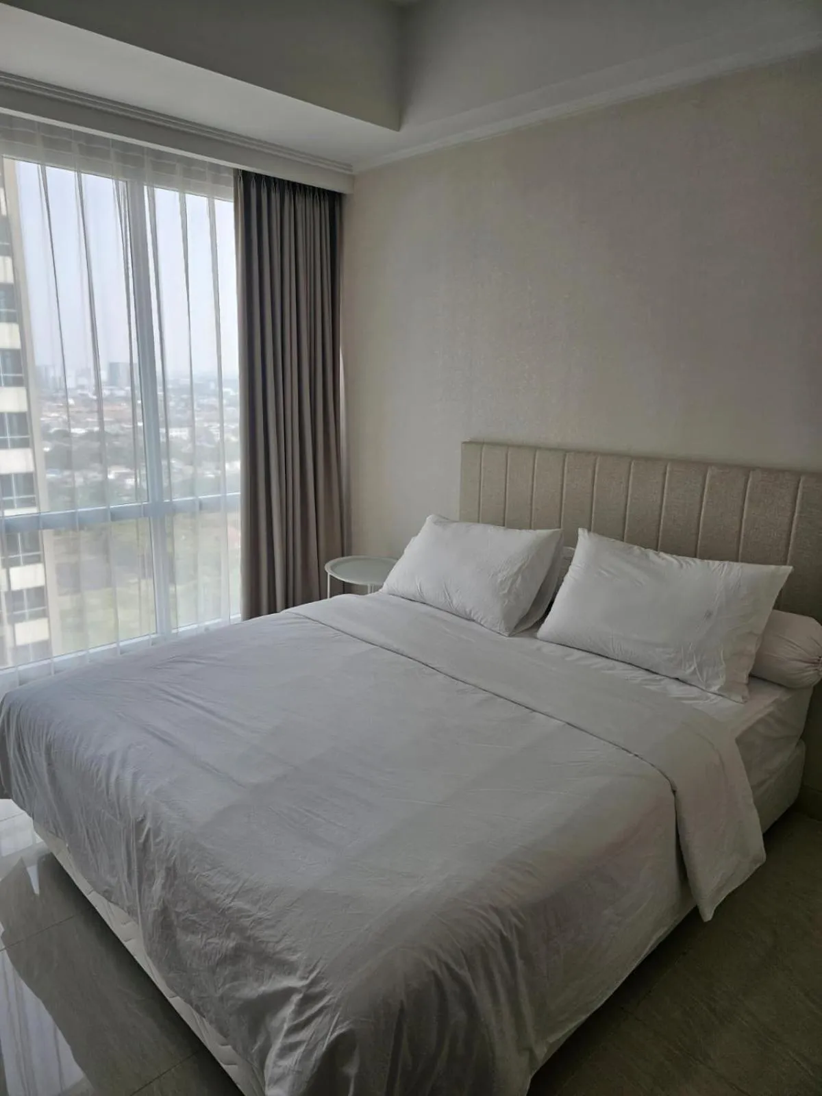 Bed in Green Sedayu Apartment Suite by Ellison