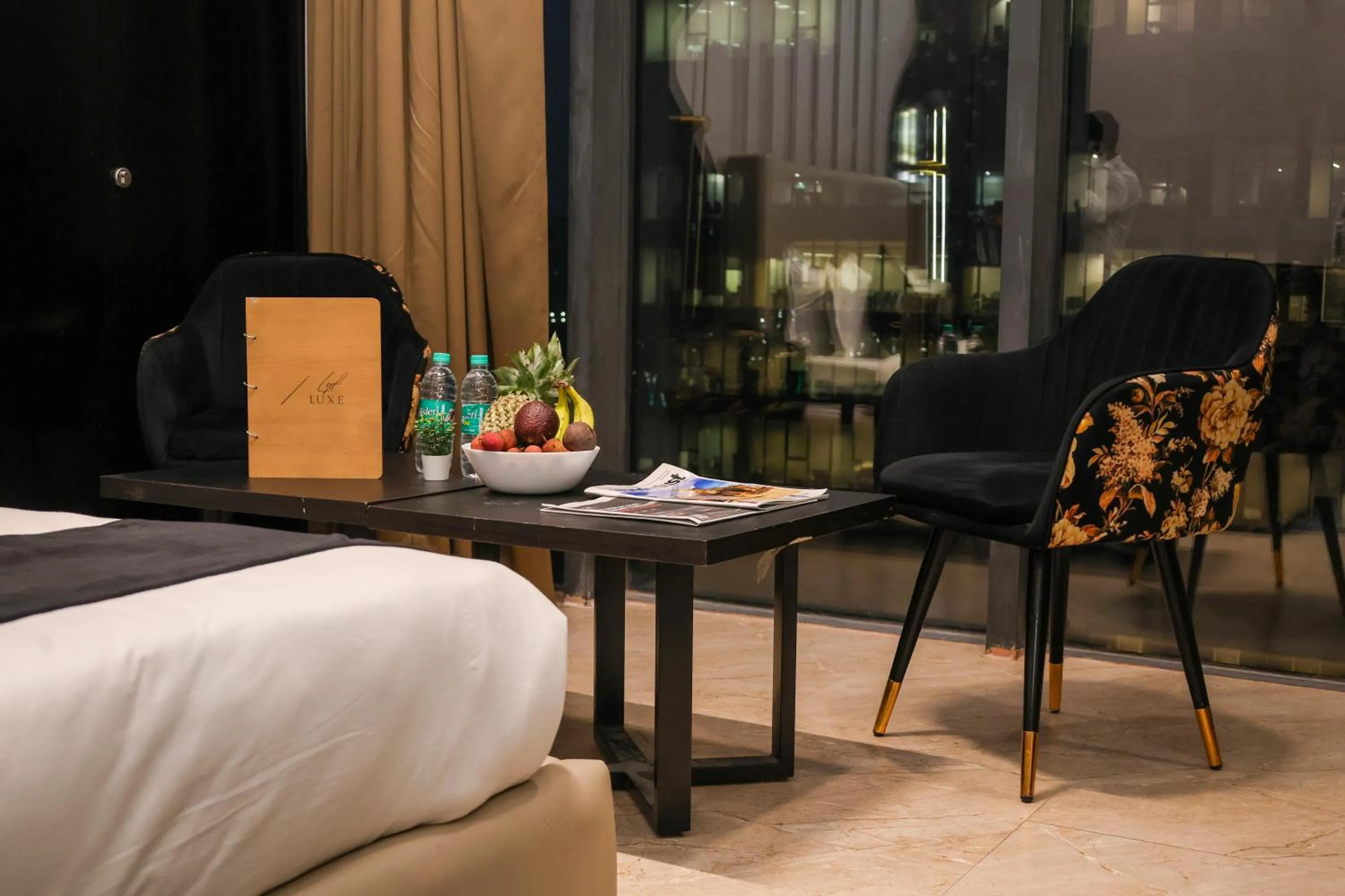 Seating area, Bed in Aquila Grand Suites - Noida Sector 136