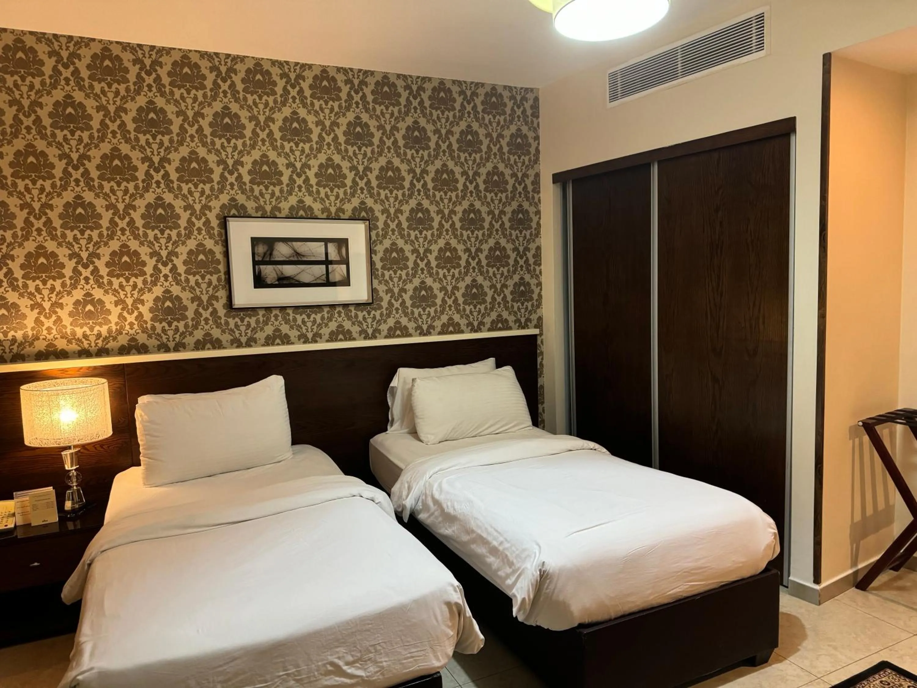 Bed in City Rose Hotel Suites