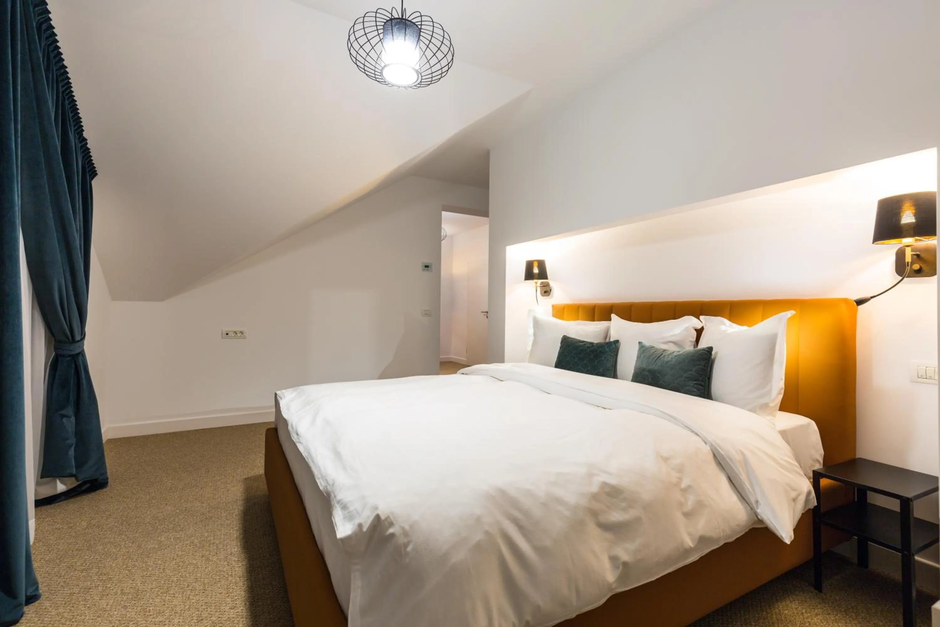 Bed in UpperHouse Suites & More