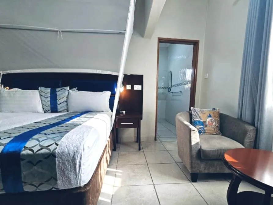 Seating area, Bed in Maun Executive Inn