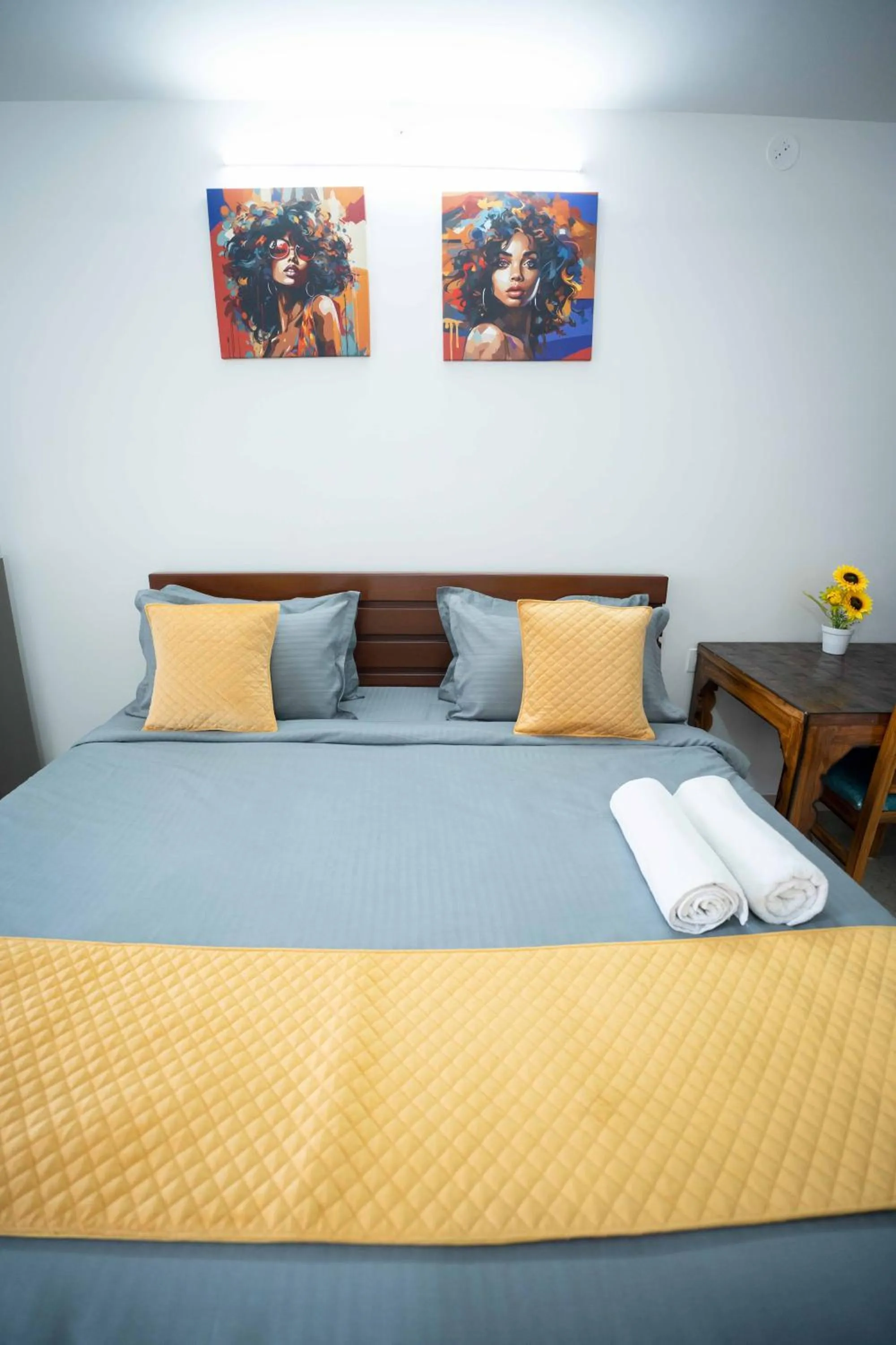 Bed in Yellow Bells Studios And Suites