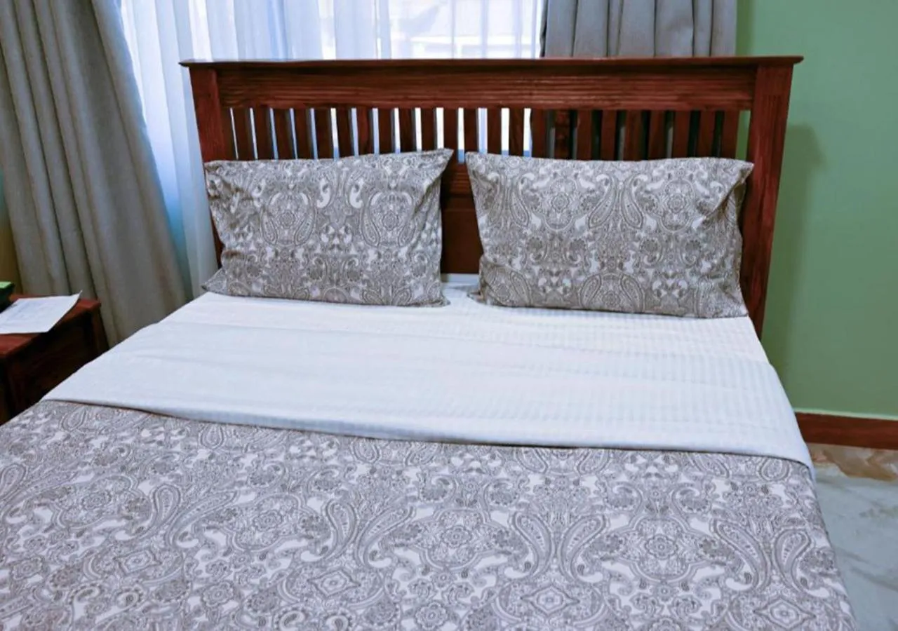 Bed in Neon Hotel Ntinda