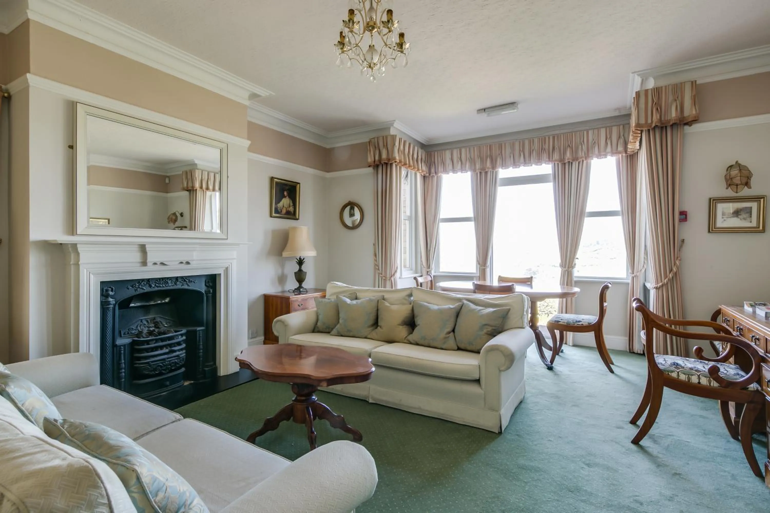 Communal lounge/ TV room in Cleeve Hill Hotel