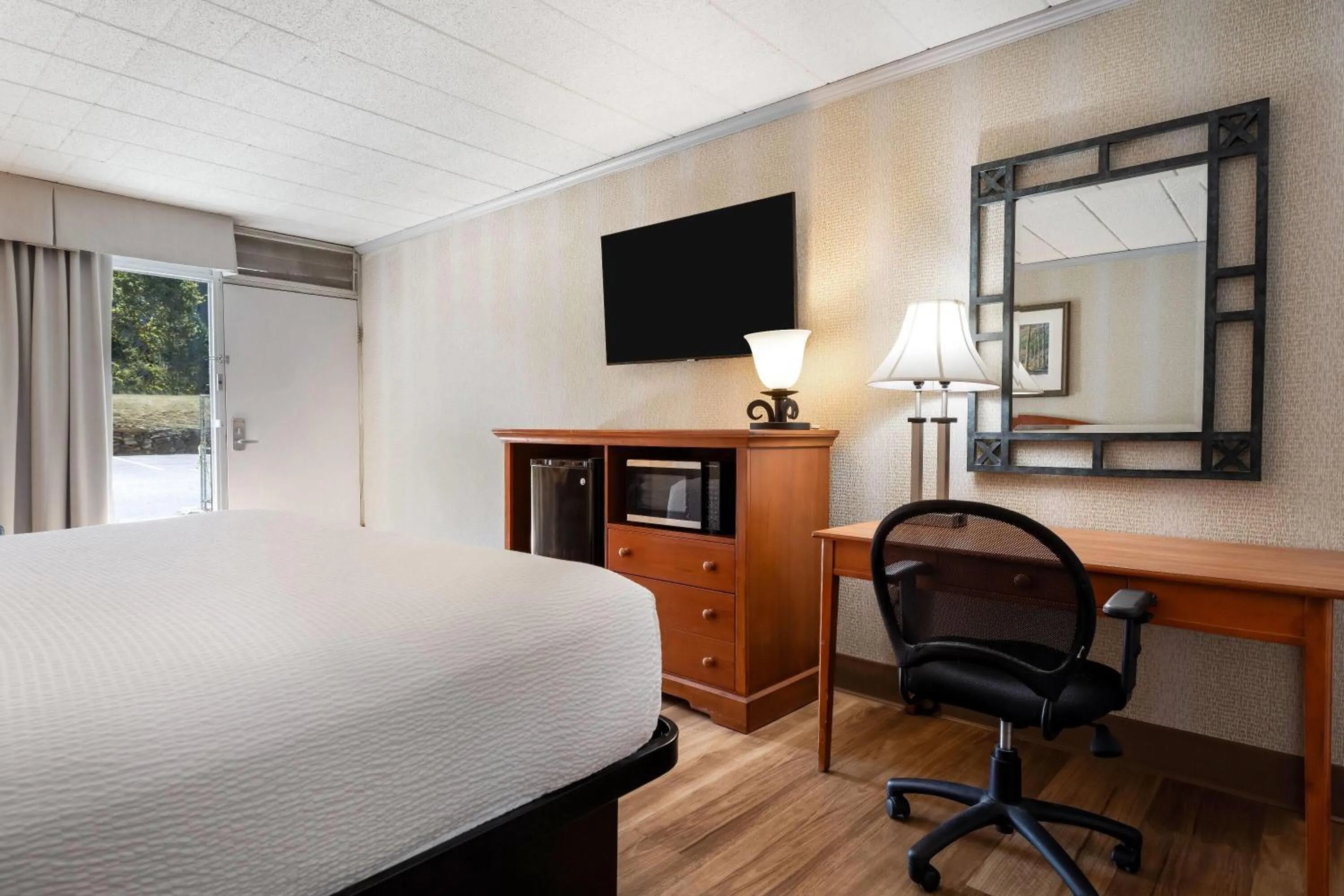 Bed in Ramada by Wyndham State College Hotel & Conference Center