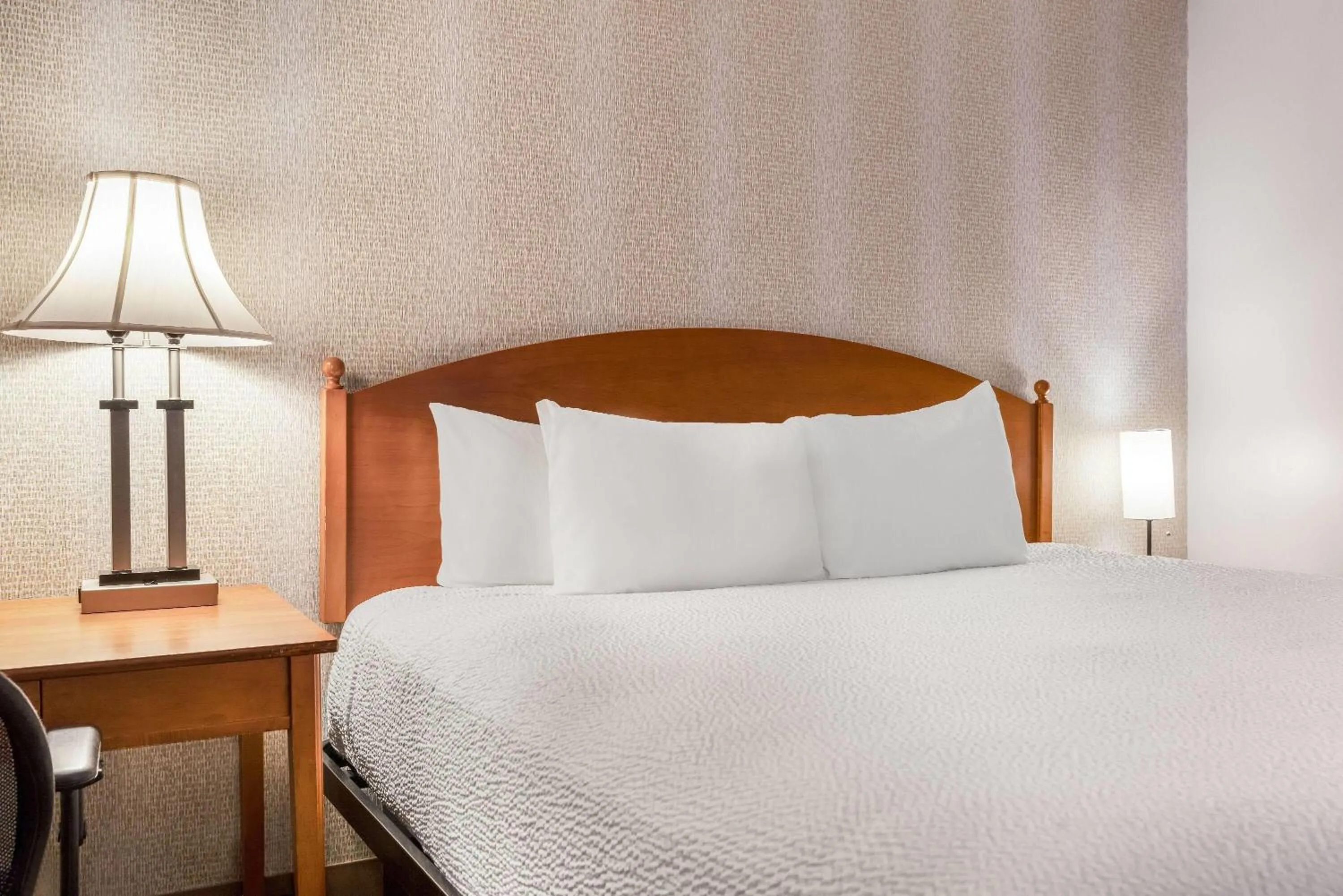 Bed in Ramada by Wyndham State College Hotel & Conference Center