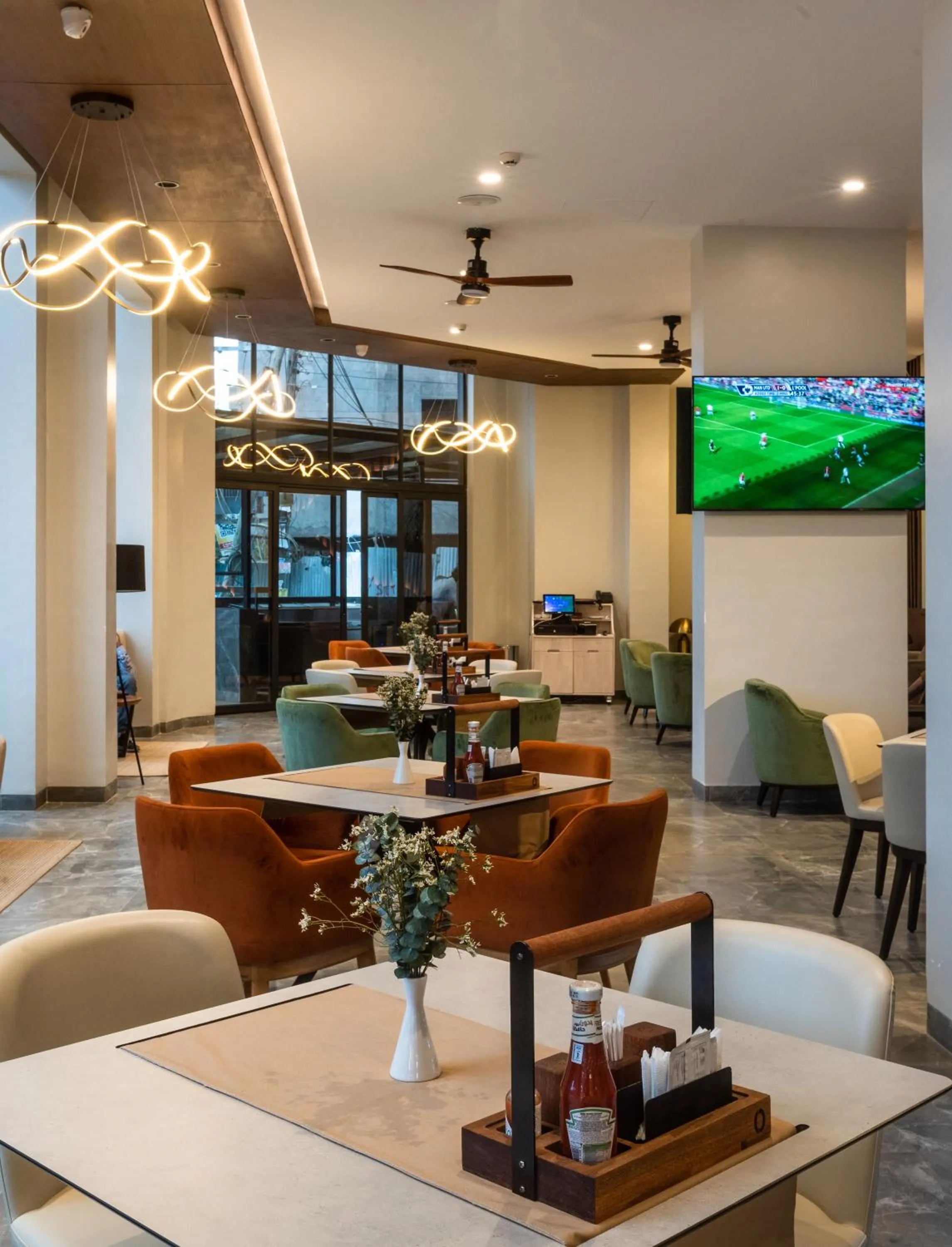 Communal lounge/ TV room in Okash City Boutique Hotel