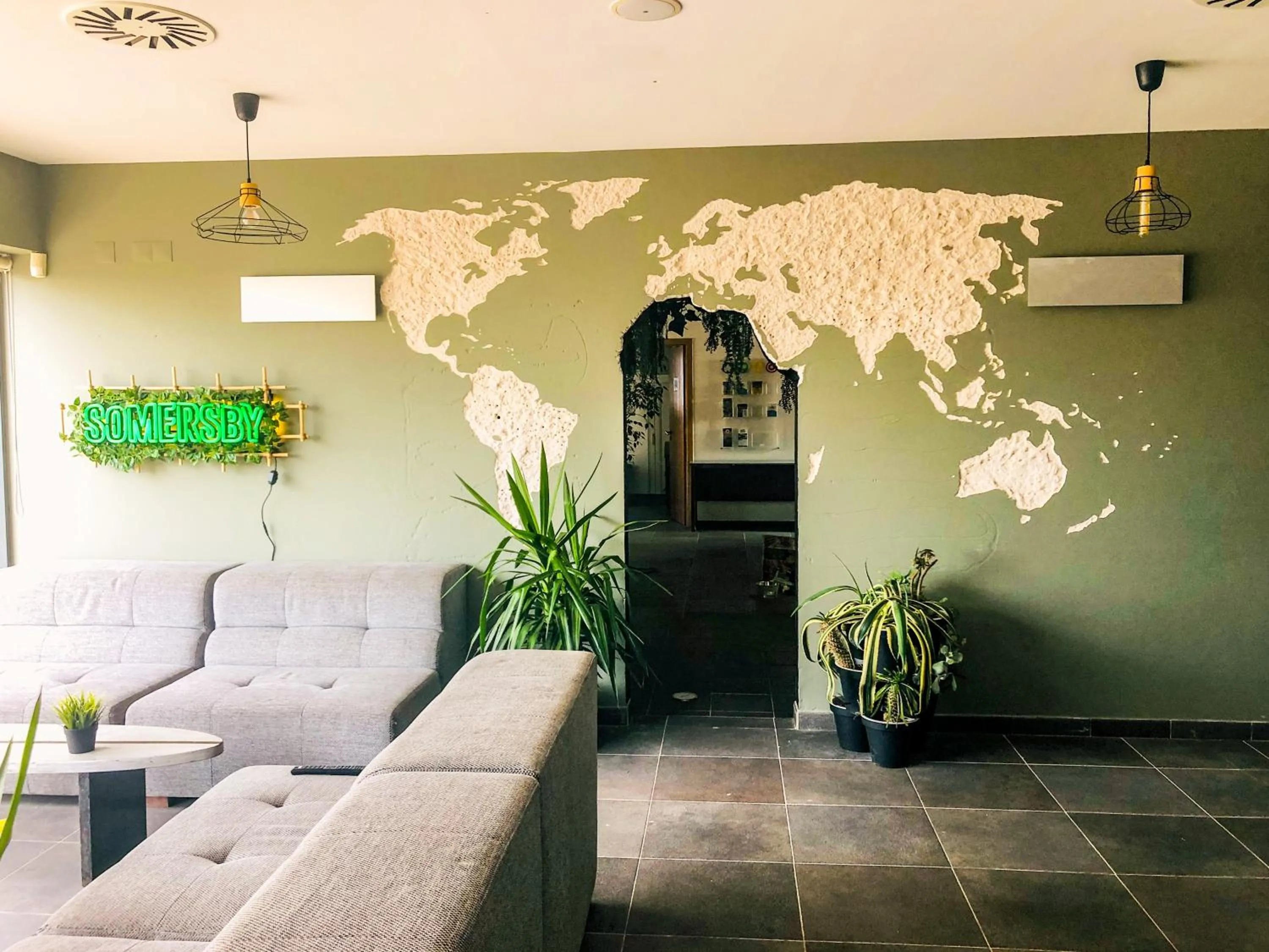 Communal lounge/ TV room in HI Arrifana Destination Hostel