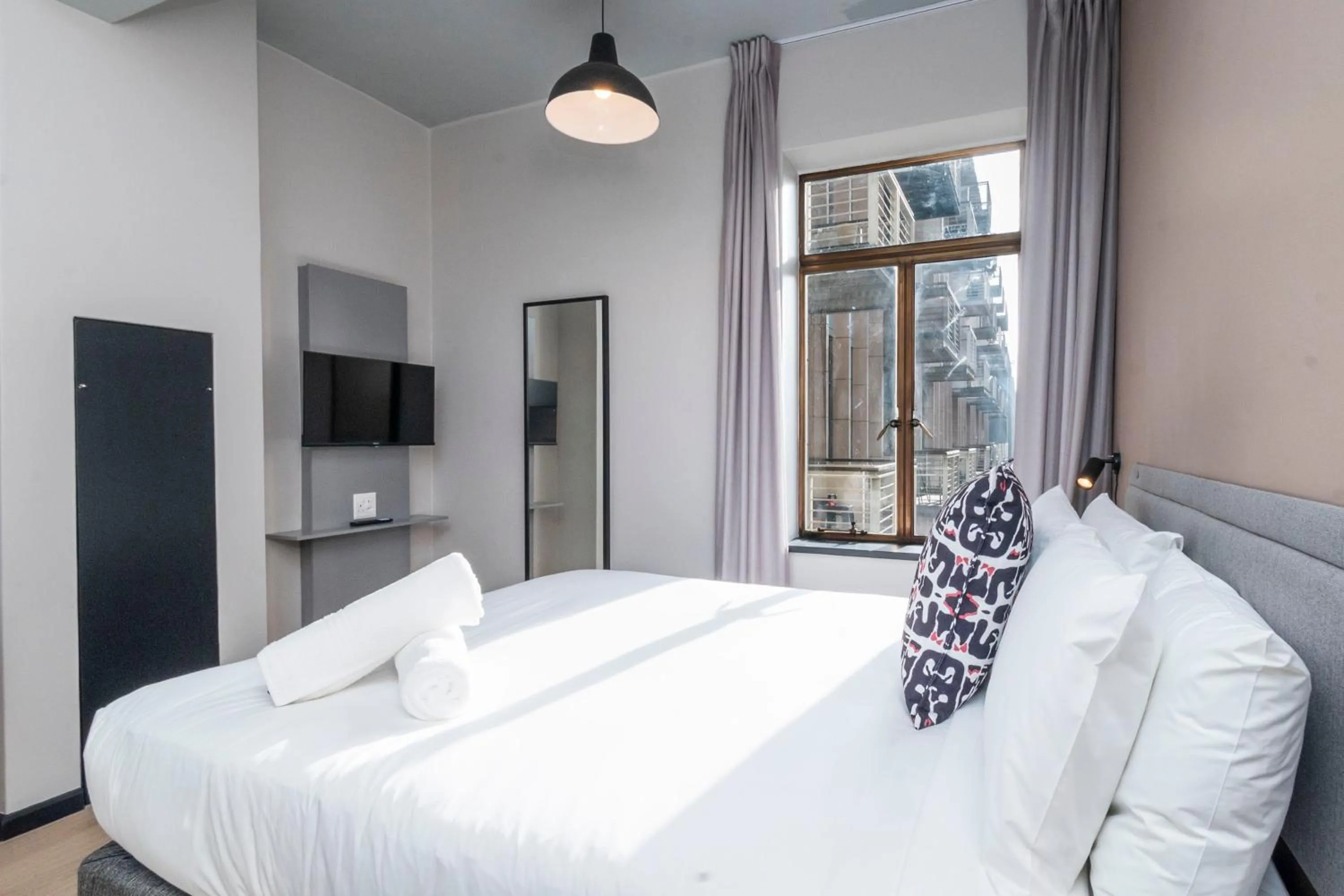 Bed in HAVN Aparthotel by Totalstay