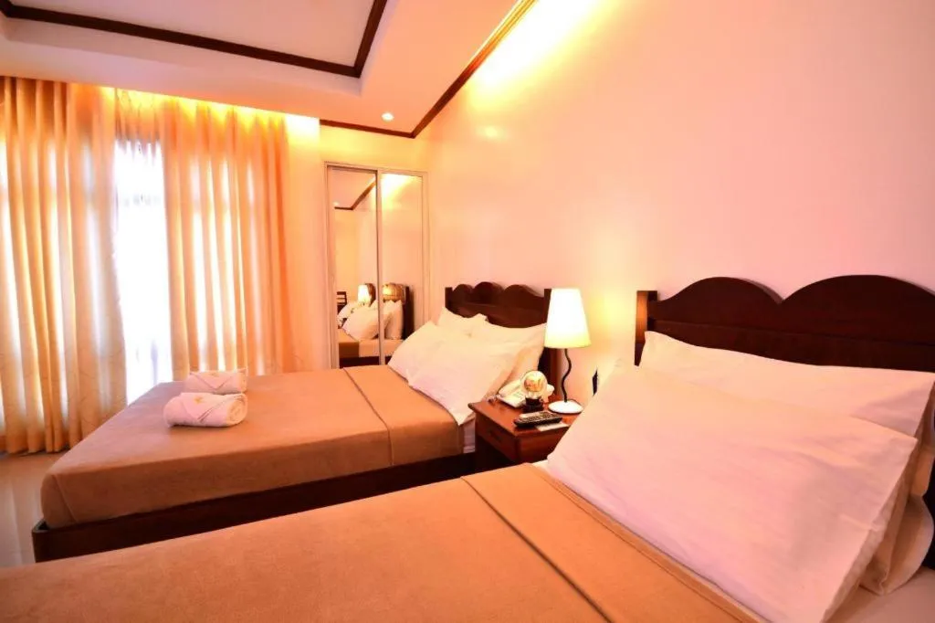 Bed in Ipil Suites Puerto Princesa