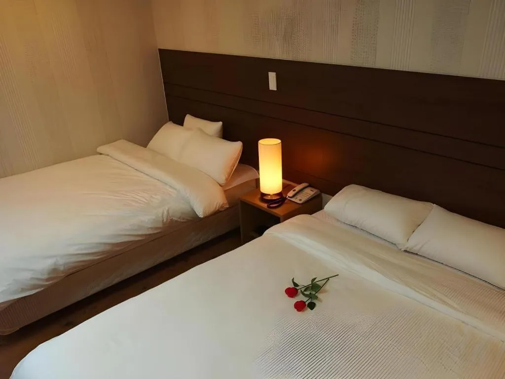 Bed in CJ Tourist Hotel