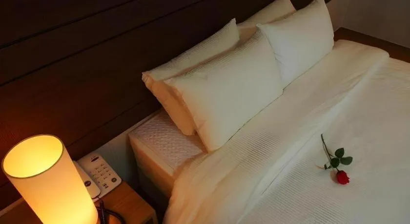 Bed in CJ Tourist Hotel