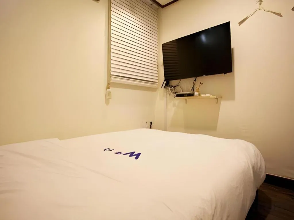 Bed in W Mini Hotel